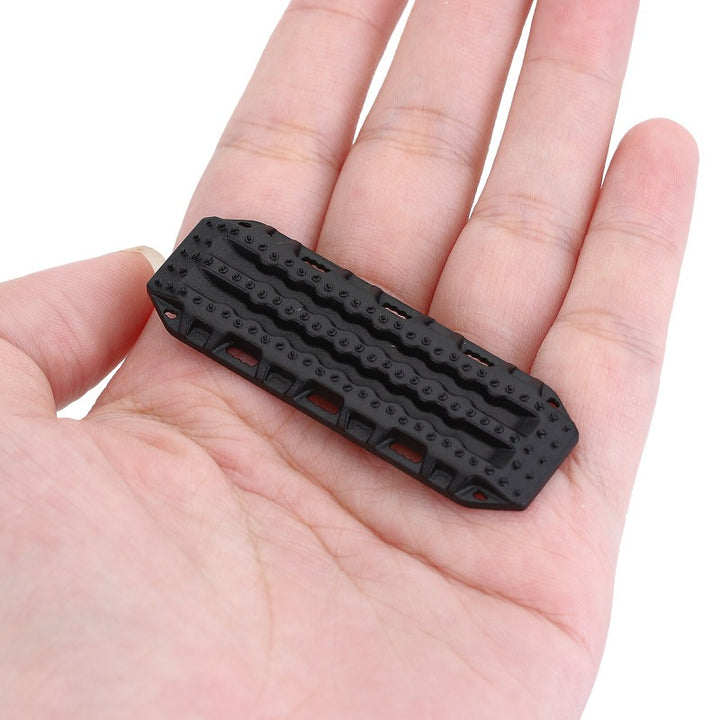 a Black Plastic Sand Ladder Board on a hand