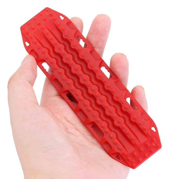 Mini Red Plastic Sand Ladder Recovery Board on a hand