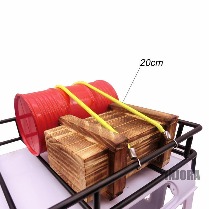 2 yellow ropes tied a oil drum and a Wooden box