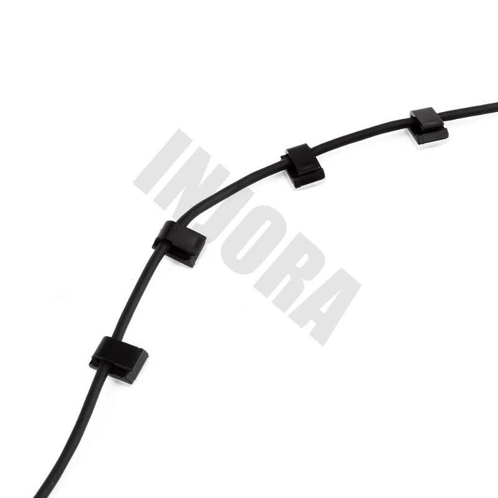 a black wire passed through 4 Wiring Buckles