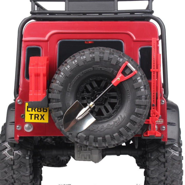 a red rc crawler back, with tire Shovel and jack